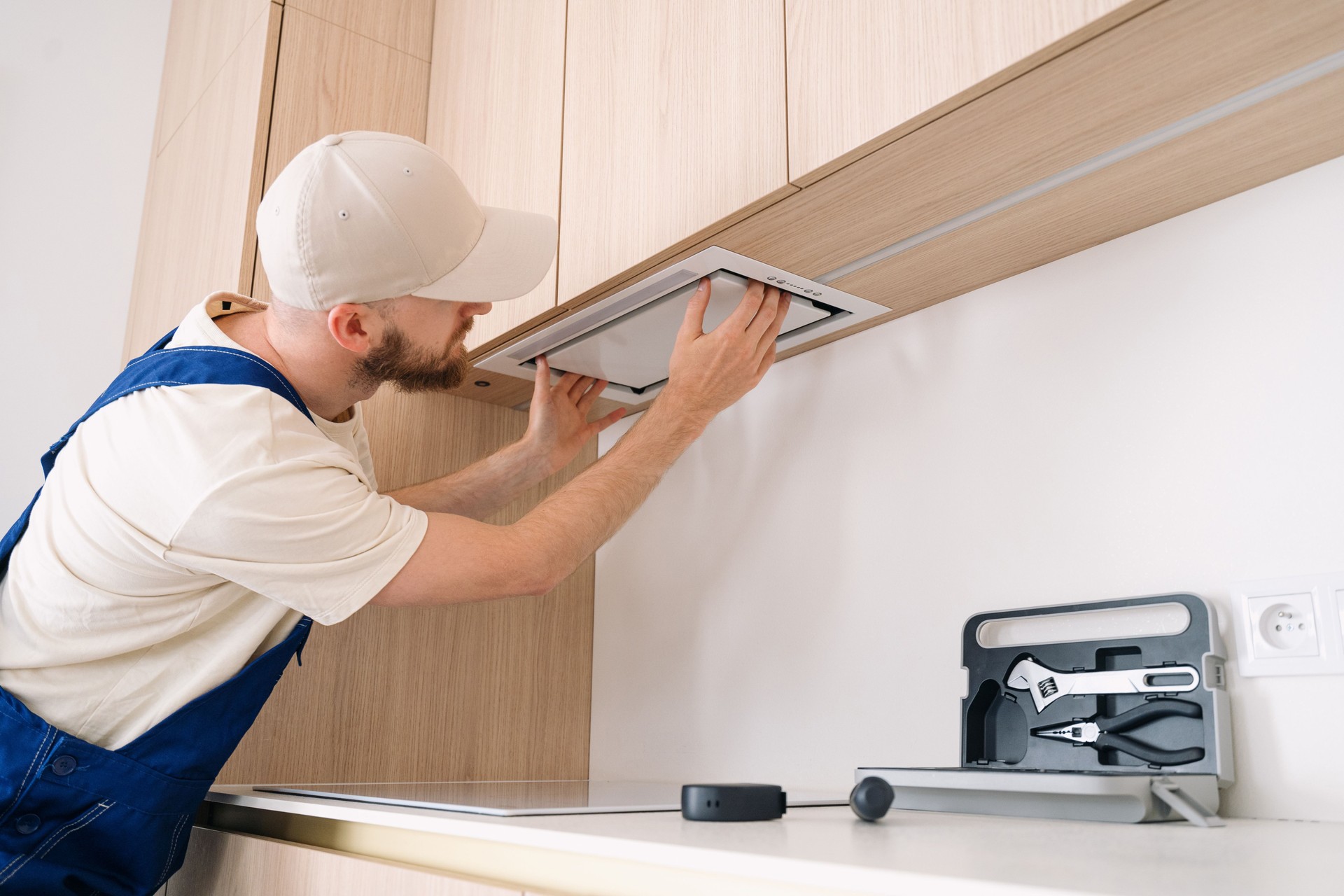 Man performs cabinet installation in a modern kitchen renovation